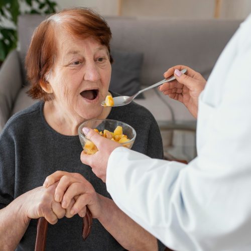 close-up-old-woman-being-fed